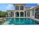 A beautiful home exterior with a spacious pool and covered patio at 8016 Bounty Ln, Bradenton, FL 34202
