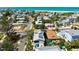 Charming neighborhood with the home highlighted and surrounded by lush foliage and a pristine beach nearby at 802 N Bay Blvd, Anna Maria, FL 34216