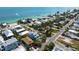 Coastal living at its finest with this aerial view of a home near tranquil ocean waters and swaying palm trees at 802 N Bay Blvd, Anna Maria, FL 34216