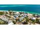 Beautiful aerial view of beachfront property with lush landscaping and turquoise water at 802 N Bay Blvd, Anna Maria, FL 34216