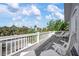 Spacious outdoor balcony with relaxing lounge chairs and scenic neighborhood views at 802 N Bay Blvd, Anna Maria, FL 34216