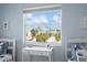 Light and airy bedroom featuring a beach view and a small writing desk by the window at 802 N Bay Blvd, Anna Maria, FL 34216
