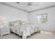 Bright bedroom featuring a large bed, nightstand and a large window at 802 N Bay Blvd, Anna Maria, FL 34216