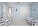 Bright bedroom with fresh pale-blue paint, features a double closet and an open doorway at 802 N Bay Blvd, Anna Maria, FL 34216