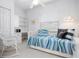 Cozy bedroom with a daybed, shelves, and a comfortable rocking chair at 802 N Bay Blvd, Anna Maria, FL 34216
