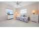 Comfortable bedroom with a ceiling fan and water view; adorned with charming nautical-themed decor at 802 N Bay Blvd, Anna Maria, FL 34216