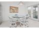 Bright dining area with glass table, wicker chairs, and sliding doors to the outside at 802 N Bay Blvd, Anna Maria, FL 34216