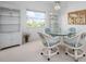 Bright dining area with glass table, wicker chairs, and view of the outside at 802 N Bay Blvd, Anna Maria, FL 34216