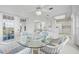 Bright dining area with glass table, wicker chairs, bar seating and open floor plan at 802 N Bay Blvd, Anna Maria, FL 34216