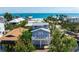 Charming beach house with a balcony, two-car garage, and tropical landscaping at 802 N Bay Blvd, Anna Maria, FL 34216