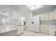 Bright kitchen with stainless steel appliances, white cabinetry, and ample counter space at 802 N Bay Blvd, Anna Maria, FL 34216