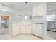 Kitchen with white cabinets, dishwasher, and eat-in breakfast area, creating a cozy space at 802 N Bay Blvd, Anna Maria, FL 34216