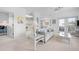 Bright living area with wicker furniture and access to the balcony, kitchen and entry door at 802 N Bay Blvd, Anna Maria, FL 34216