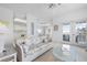 Open-concept living space with wicker furniture and access to a sunny balcony with views at 802 N Bay Blvd, Anna Maria, FL 34216