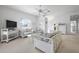 Inviting living room featuring floral wicker furniture and a view of the stairway and hallway at 802 N Bay Blvd, Anna Maria, FL 34216