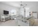 Bright living room featuring white wicker furniture with floral cushions and a ceiling fan at 802 N Bay Blvd, Anna Maria, FL 34216