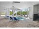 Backyard covered pool area with lounge chairs, dining table, and stairs leading to upper floor at 802 N Bay Blvd, Anna Maria, FL 34216