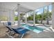Relaxing pool area with tiled patio, sun loungers, and covered space at 802 N Bay Blvd, Anna Maria, FL 34216