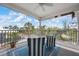 Covered porch featuring comfortable seating and views of tropical landscaping at 802 N Bay Blvd, Anna Maria, FL 34216