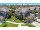 Aerial view of tan townhomes with well manicured lawns at 8073 Tybee Ct, University Park, FL 34201