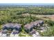 Aerial view of tan townhomes surrounded by trees in a neighborhood at 8073 Tybee Ct, University Park, FL 34201