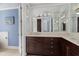 Bathroom featuring a long vanity with double sinks, granite counter tops, and modern fixtures at 8073 Tybee Ct, University Park, FL 34201