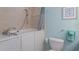 Bathroom view with walk-in tub, tiled walls, and comfort-height toilet at 8073 Tybee Ct, University Park, FL 34201