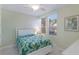Bright bedroom with ceiling fan, white wood accents, and tropical-themed bedding at 8073 Tybee Ct, University Park, FL 34201