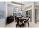 Dining room with contemporary chandelier, large window, and sliding door for ample natural light at 8073 Tybee Ct, University Park, FL 34201