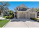 Two-story home featuring a two-car garage and an additional single-car garage at 8073 Tybee Ct, University Park, FL 34201