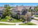 Beautifully landscaped home with a manicured lawn, palm trees, and lush plantings at 8073 Tybee Ct, University Park, FL 34201