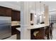 Kitchen with breakfast bar, pendant lights, dark cabinets and stainless refrigerator at 8073 Tybee Ct, University Park, FL 34201