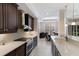 Modern kitchen featuring white countertops, stainless steel appliances, and dark cabinets at 8073 Tybee Ct, University Park, FL 34201