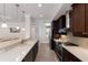 Modern kitchen featuring stainless steel appliances, quartz countertops, and dark wood cabinetry at 8073 Tybee Ct, University Park, FL 34201