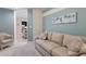 Comfortable living room with a daybed, loveseat, and a view into the kitchen at 8073 Tybee Ct, University Park, FL 34201