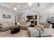 Open living room and kitchen with breakfast bar, tile floors, and neutral decor at 8073 Tybee Ct, University Park, FL 34201