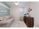 Cozy living room with a daybed, accent chair, and tropical themed artwork at 8073 Tybee Ct, University Park, FL 34201
