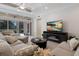 Bright living room with tile floors, neutral decor, ceiling fan, and sliding glass doors at 8073 Tybee Ct, University Park, FL 34201