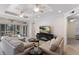 Spacious living room with tile floors, a ceiling fan, and sliding glass doors to the lanai at 8073 Tybee Ct, University Park, FL 34201