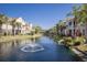 Scenic water view highlighting lush landscaping, water fountain, and the exterior of the well-maintained townhome community at 8073 Tybee Ct, University Park, FL 34201