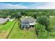 Aerial view showcasing a home with a screen-enclosed pool, well-maintained yard, and lush landscaping at 8103 Snowy Egret Pl, Bradenton, FL 34202