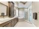 Modern bathroom with a soaking tub and a separate glass-enclosed shower and double sink at 8103 Snowy Egret Pl, Bradenton, FL 34202