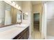 Bathroom with single sink, brown cabinets and grey countertops at 8103 Snowy Egret Pl, Bradenton, FL 34202