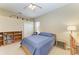 Cozy bedroom with neutral walls, carpet, ceiling fan, and upper storage boxes at 8103 Snowy Egret Pl, Bradenton, FL 34202