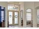 Welcoming foyer featuring tile flooring, high ceilings, and a beautiful chandelier fixture at 8103 Snowy Egret Pl, Bradenton, FL 34202