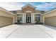Charming home with a stone facade, double front doors, and a spacious three-car garage at 8103 Snowy Egret Pl, Bradenton, FL 34202