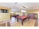 The game room includes a pool table, dartboard, and comfortable seating area at 8103 Snowy Egret Pl, Bradenton, FL 34202