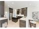 Modern kitchen with stainless steel appliances, white countertops, and dark wood cabinets at 8103 Snowy Egret Pl, Bradenton, FL 34202