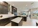 Sleek kitchen with stainless steel appliances, white countertops, dark cabinets and an island at 8103 Snowy Egret Pl, Bradenton, FL 34202