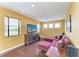 Comfortable living room with hardwood floors, large screen TV, and plenty of natural light at 8103 Snowy Egret Pl, Bradenton, FL 34202